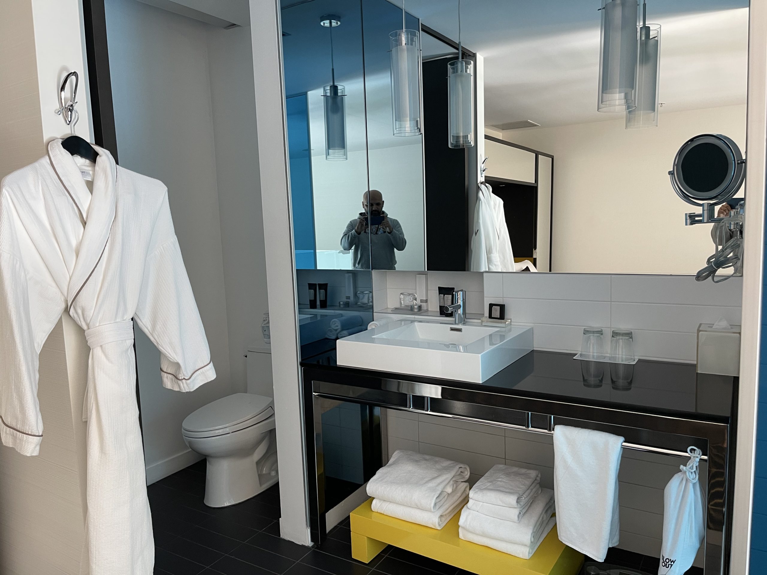 a bathroom with a mirror and a bathrobe