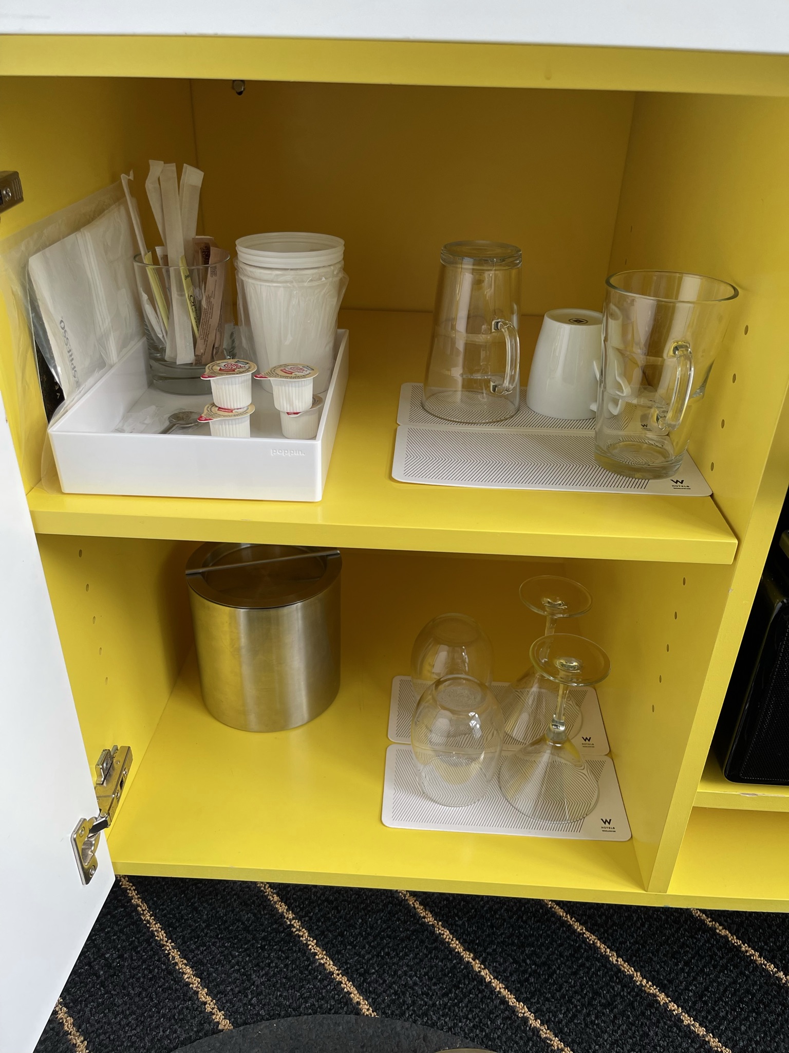 a shelf with glasses and cups on it