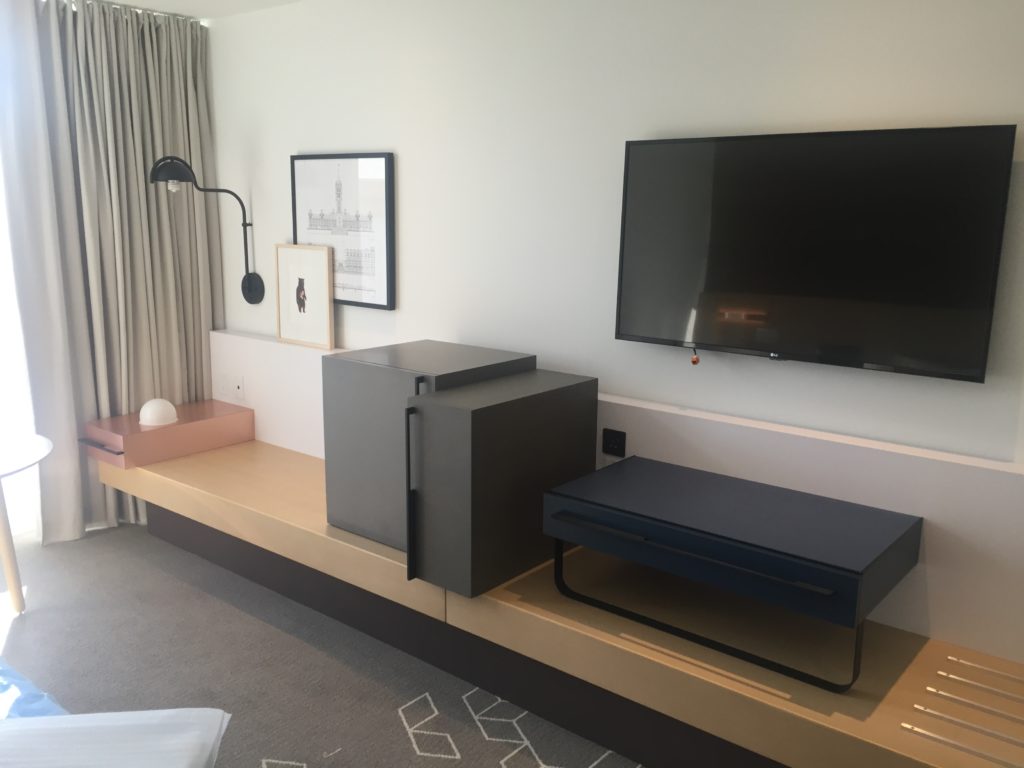 Contemporary furnishings with minibar, storage space and seating room.