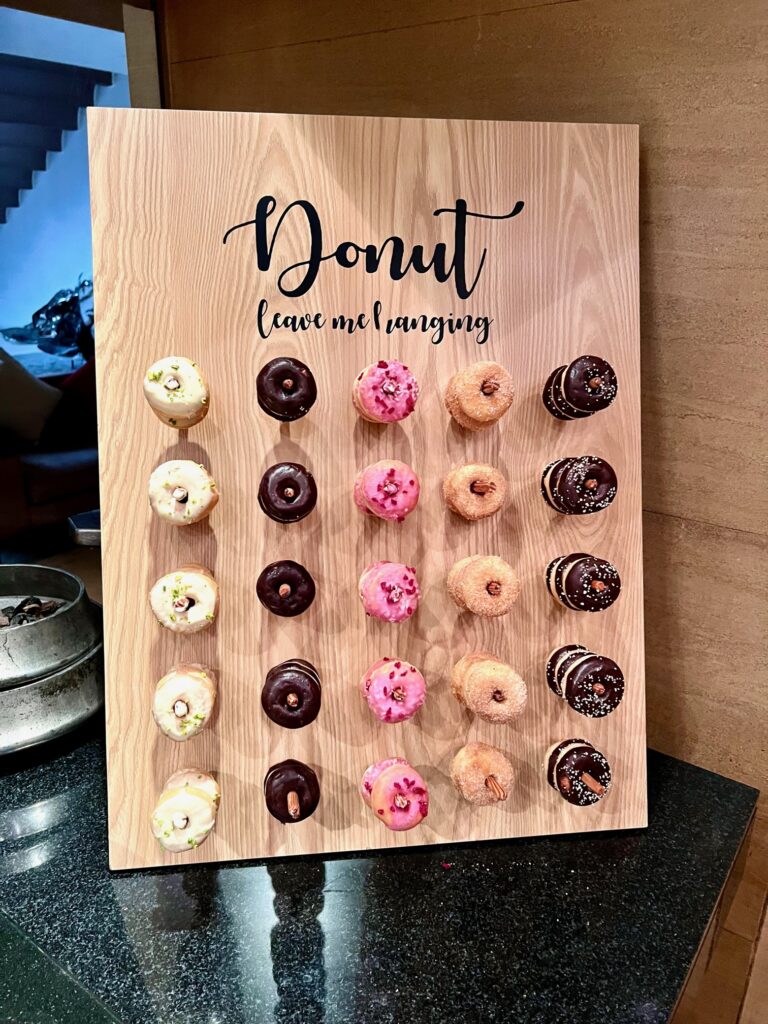 a wooden board with donuts on it