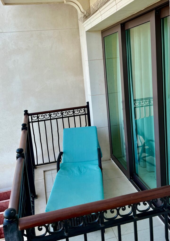 a blue lounge chair on a balcony