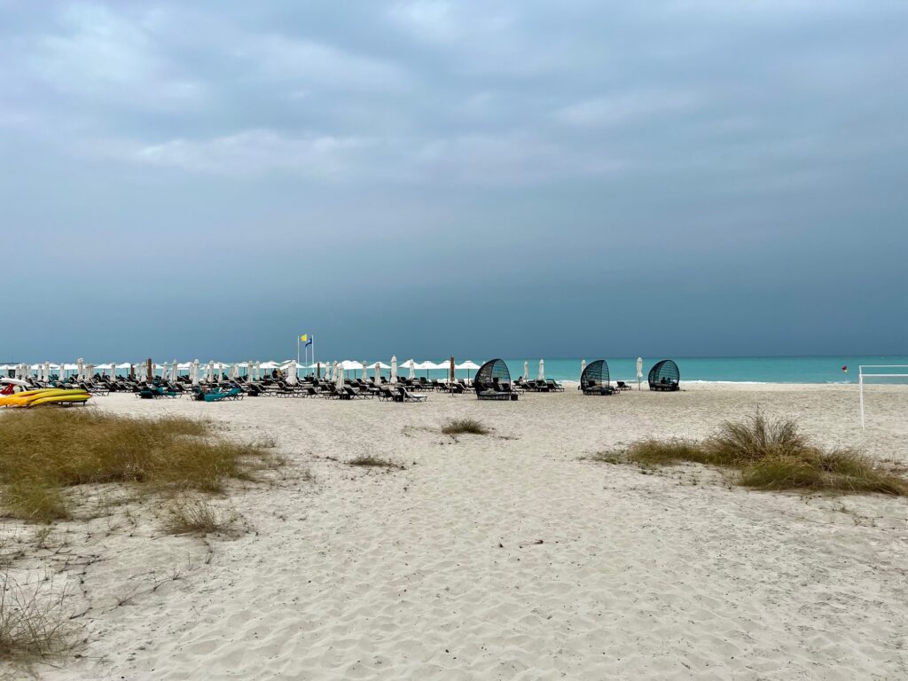 a beach with umbrellas and chairs