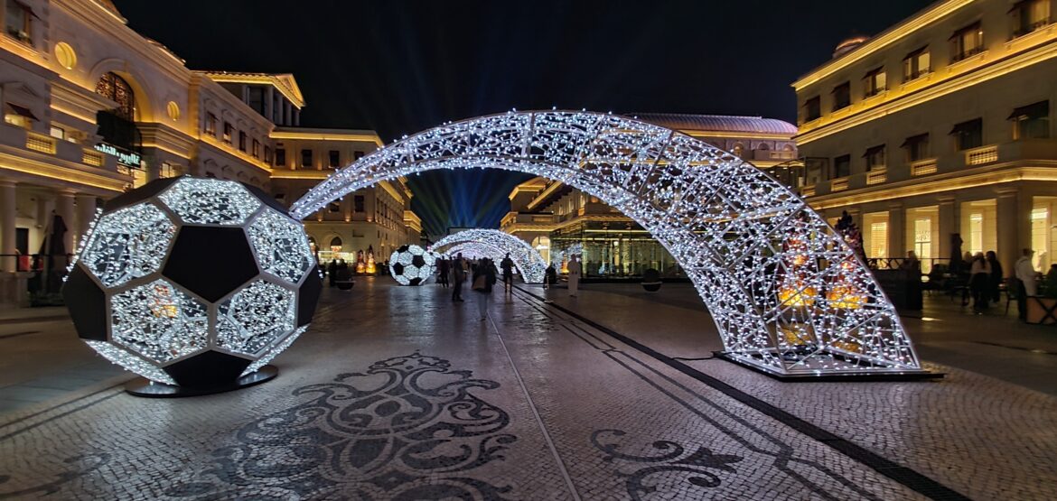 a large archway with lights and football balls