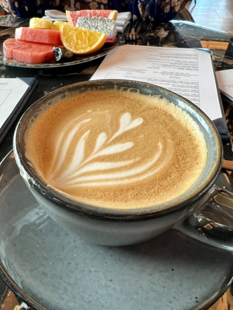 a cup of coffee with a leaf design on top