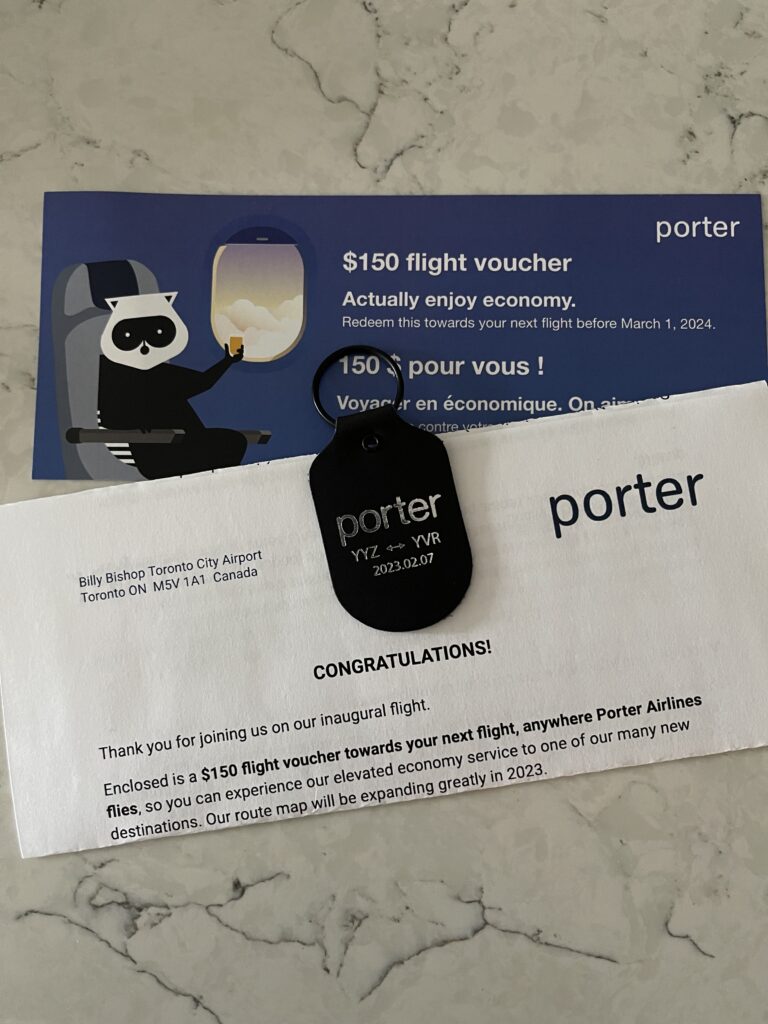 a voucher and a keychain on a marble surface