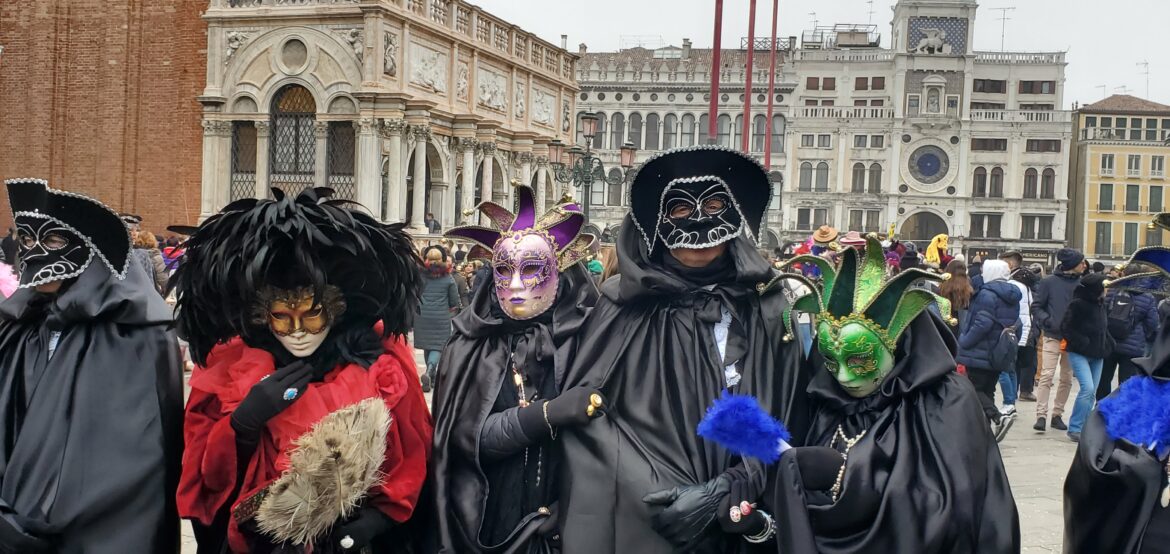 a group of people wearing masks and clothing