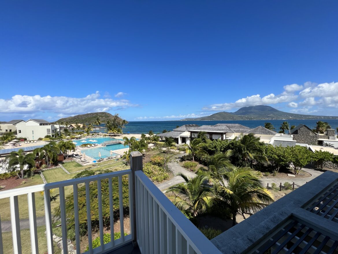 DB09D8D6-A440-49D2-B14B-E3B529129B5E a balcony overlooking a body of water and a beach