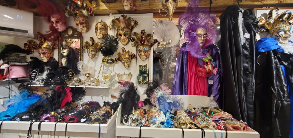 a display of masks and feathers