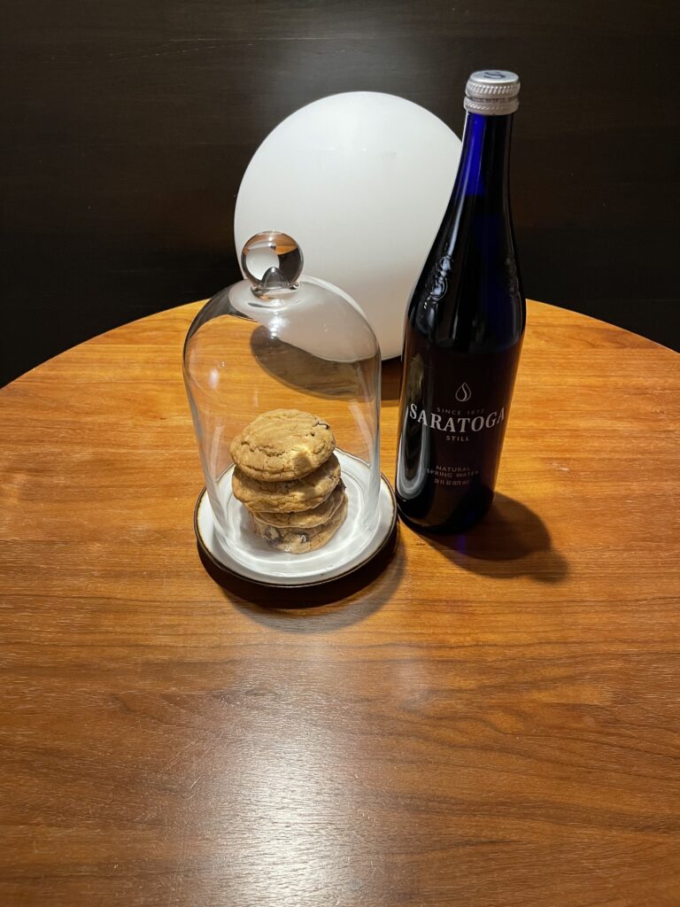 a bottle of wine and cookies on a table