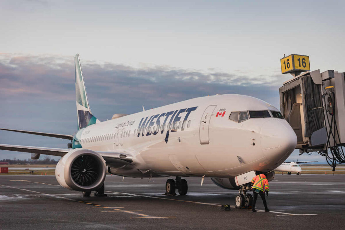1200-westjet-yvr-5 a white airplane on the tarmac