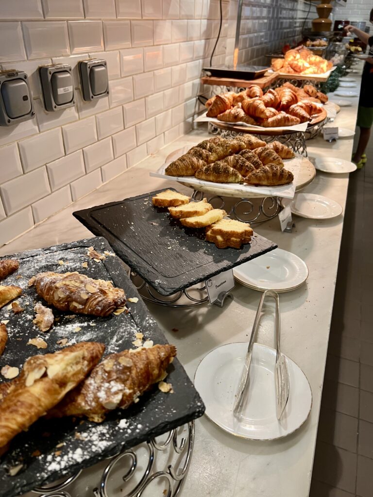 a buffet table with pastries and bread