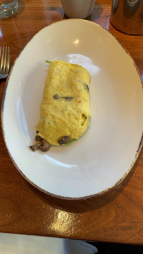 a plate of omelette with mushrooms on it