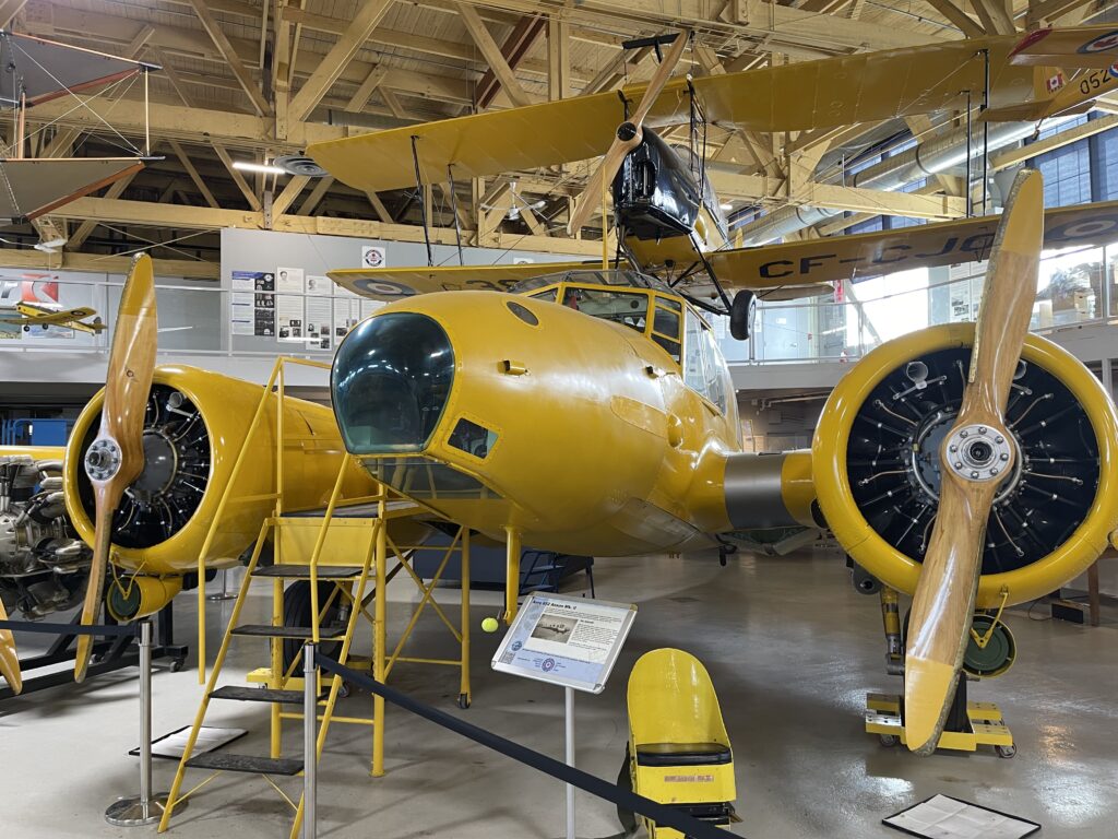 a yellow airplane in a hangar