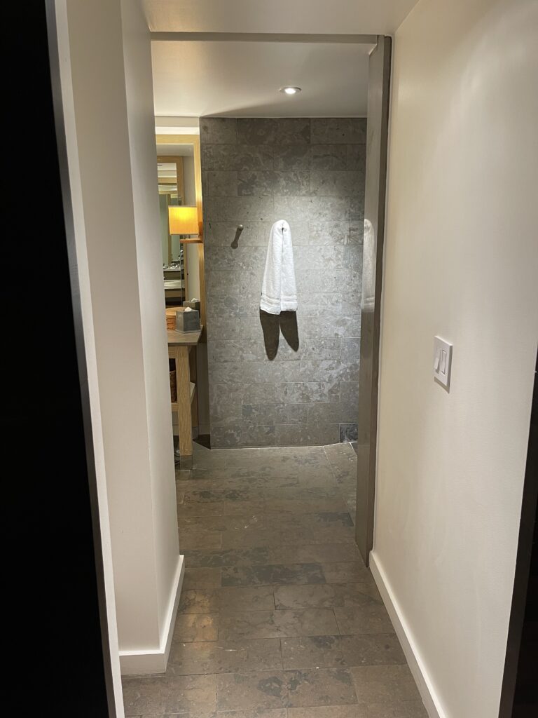 a white towel on a hook in a hallway