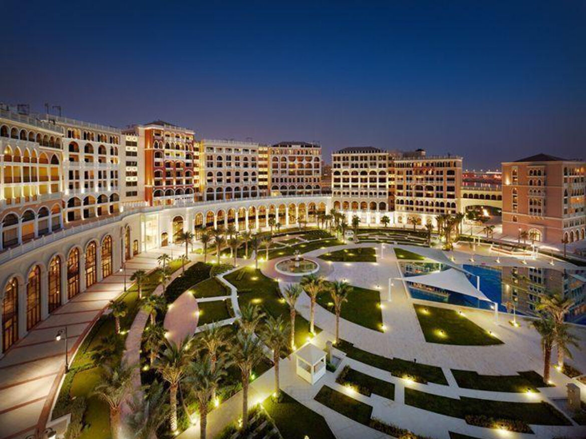 a large building with many windows and a pool