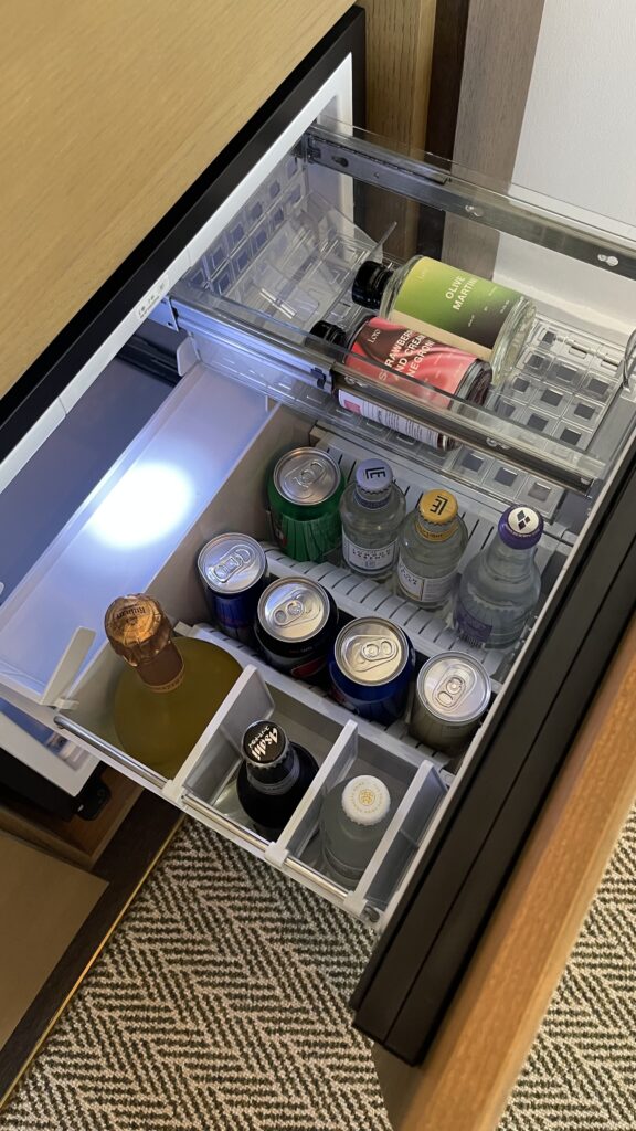 a refrigerator with drinks and bottles inside