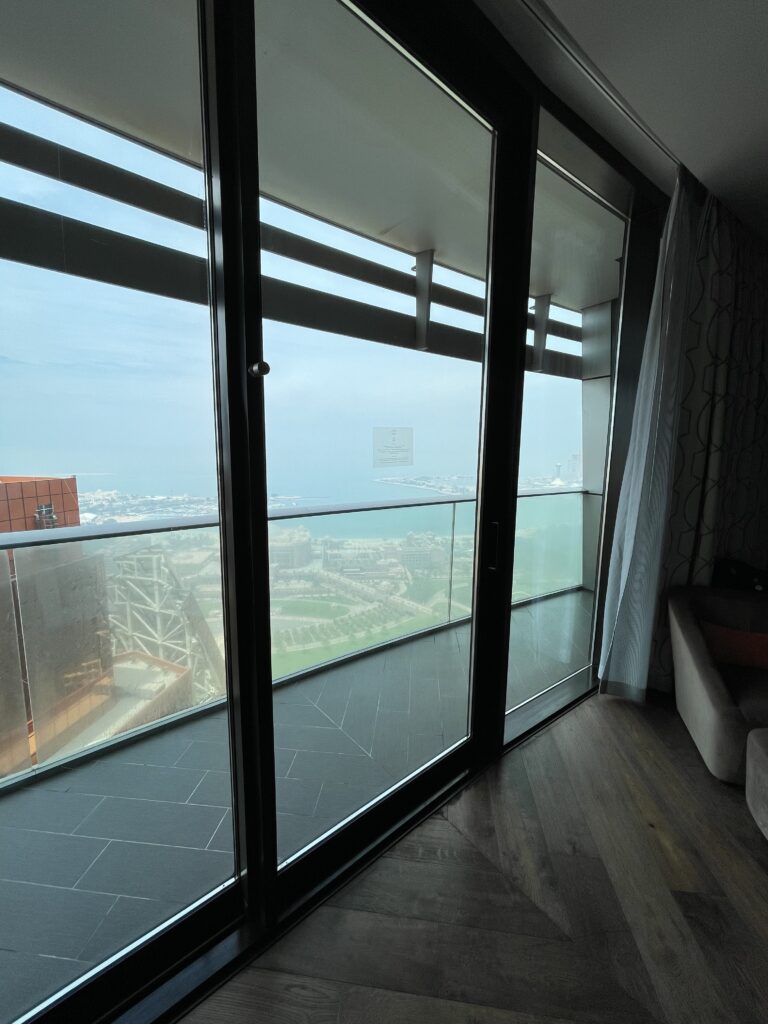 a room with glass doors and a view of a city