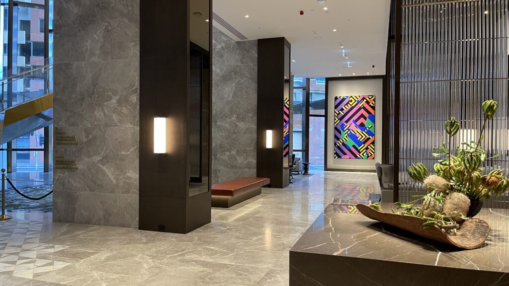 a lobby with a painting on the wall
