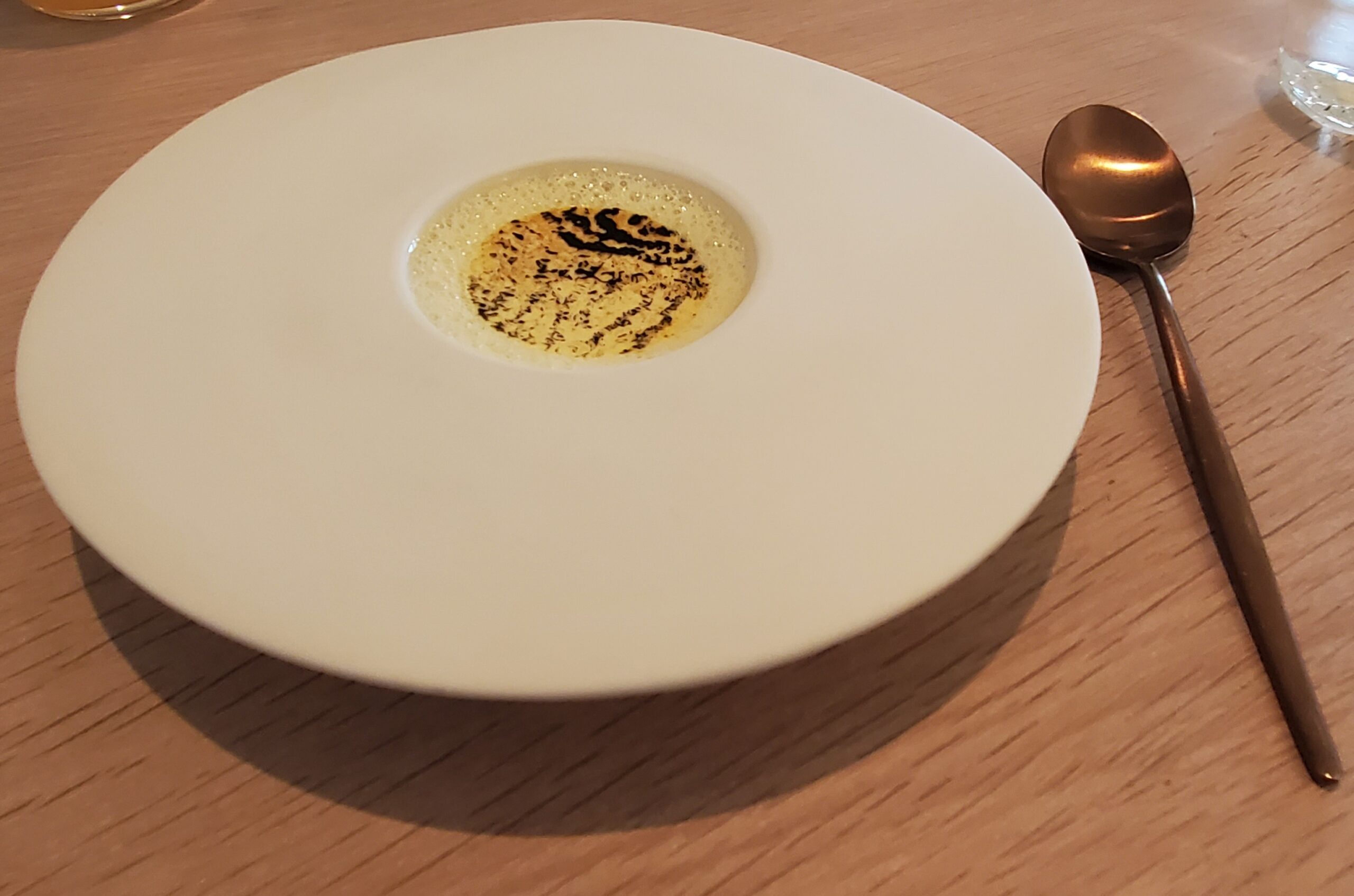 a plate with a white circle with a brown substance in it