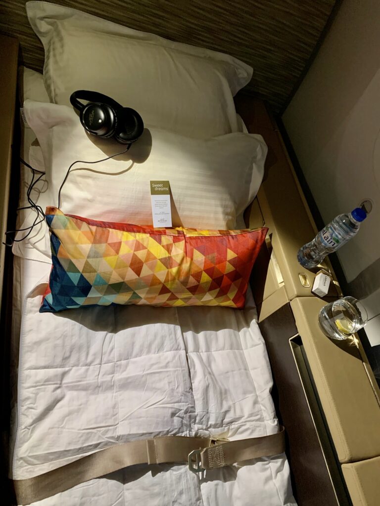 a bed with headphones and a pillow