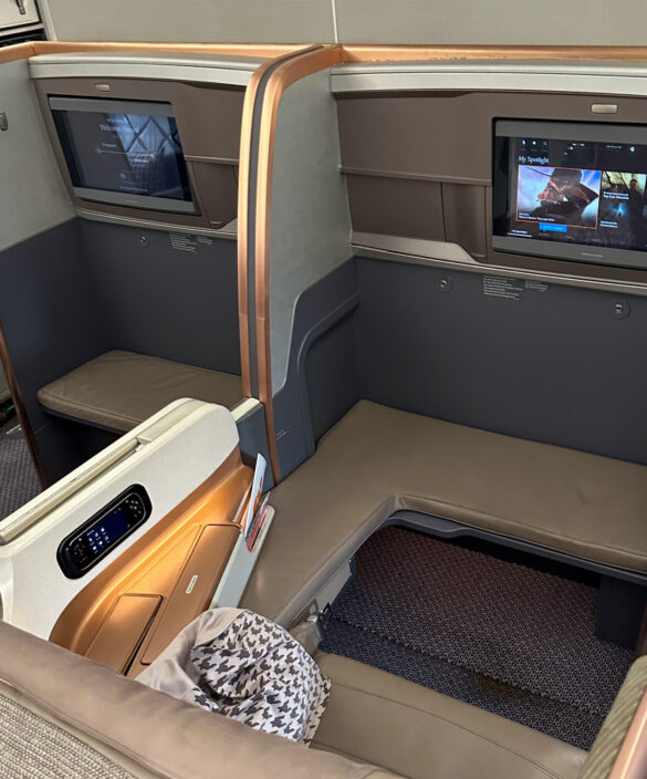 a seat and a television in a plane