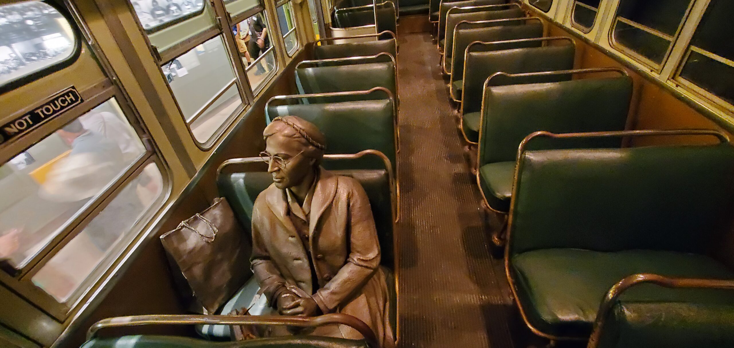 a statue of a woman sitting in a bus