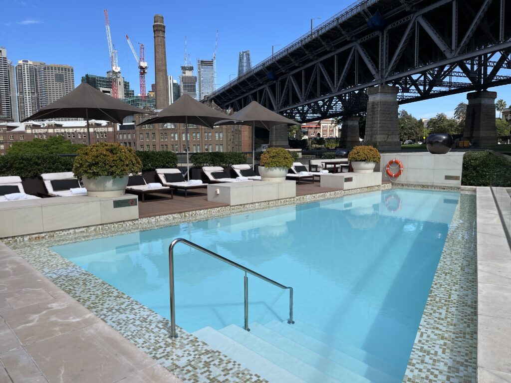 a swimming pool with a bridge in the background