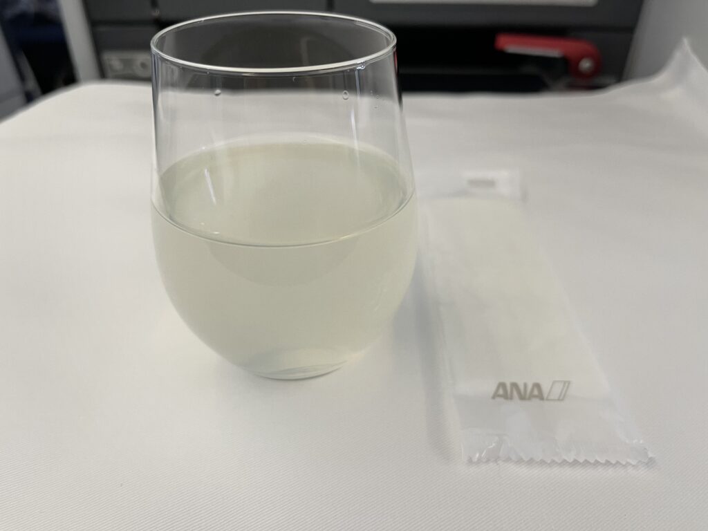 a glass of liquid and a napkin