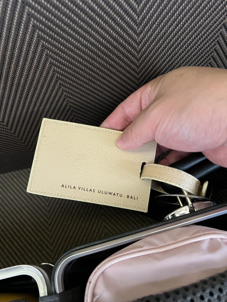 a hand holding a tag in a suitcase