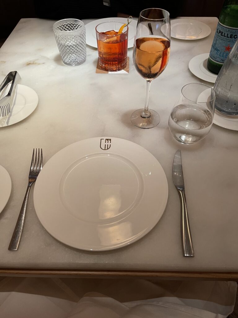a table with plates and glasses of wine
