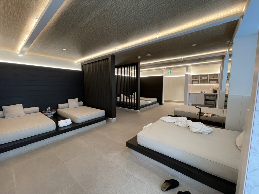 a room with beds and a black wall