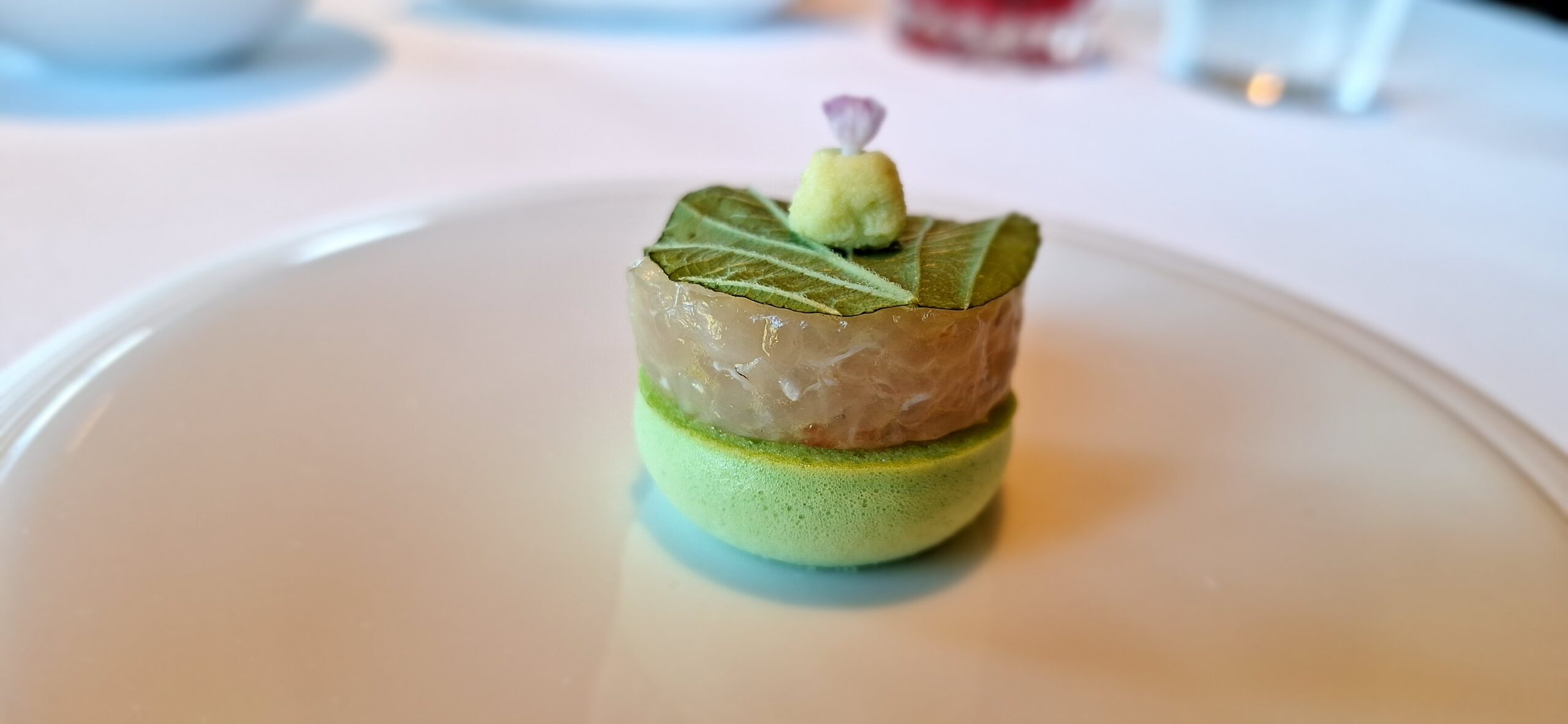 a small green dessert on a white plate