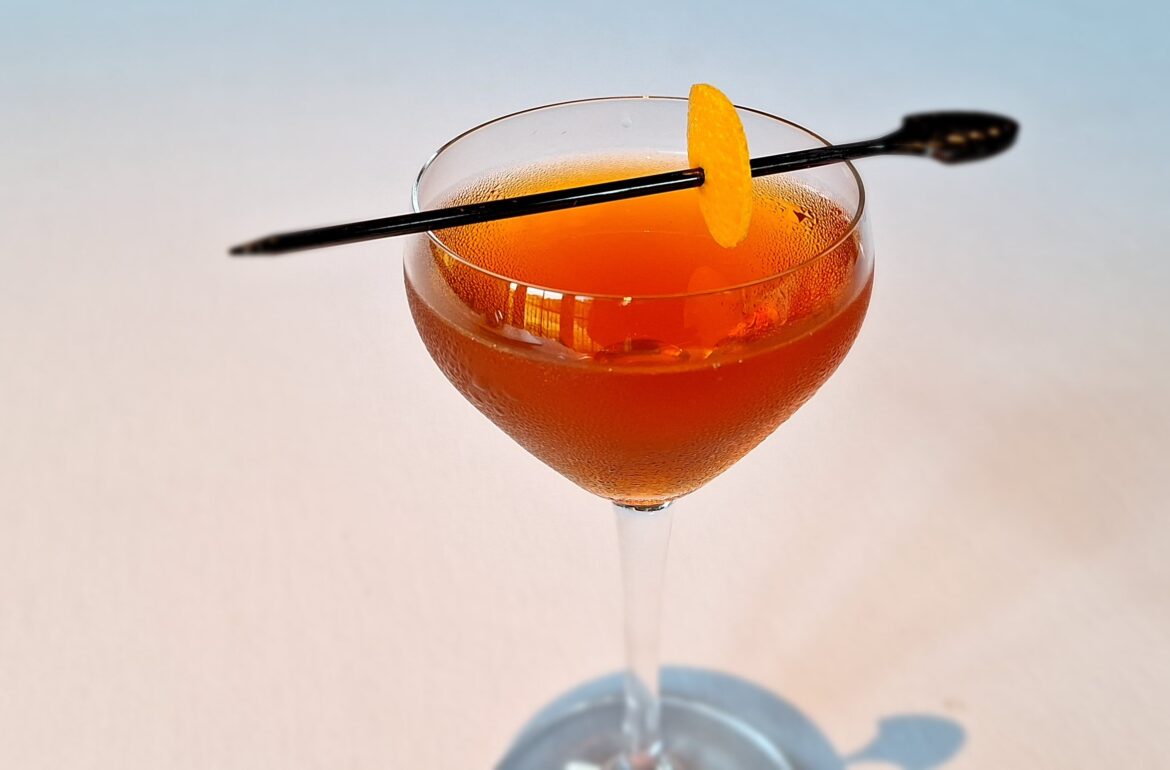 a glass with a drink and a stick