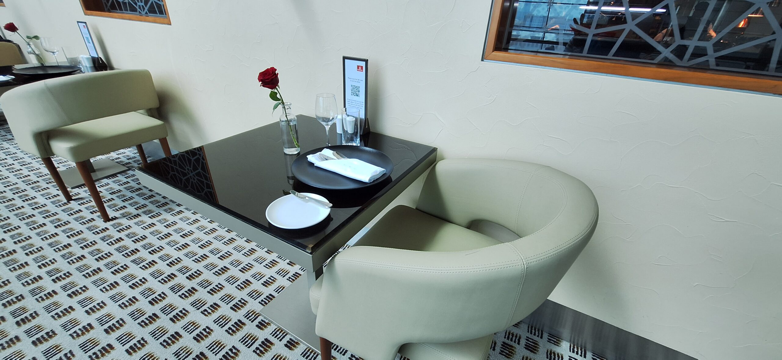 a table with plates and a rose on it