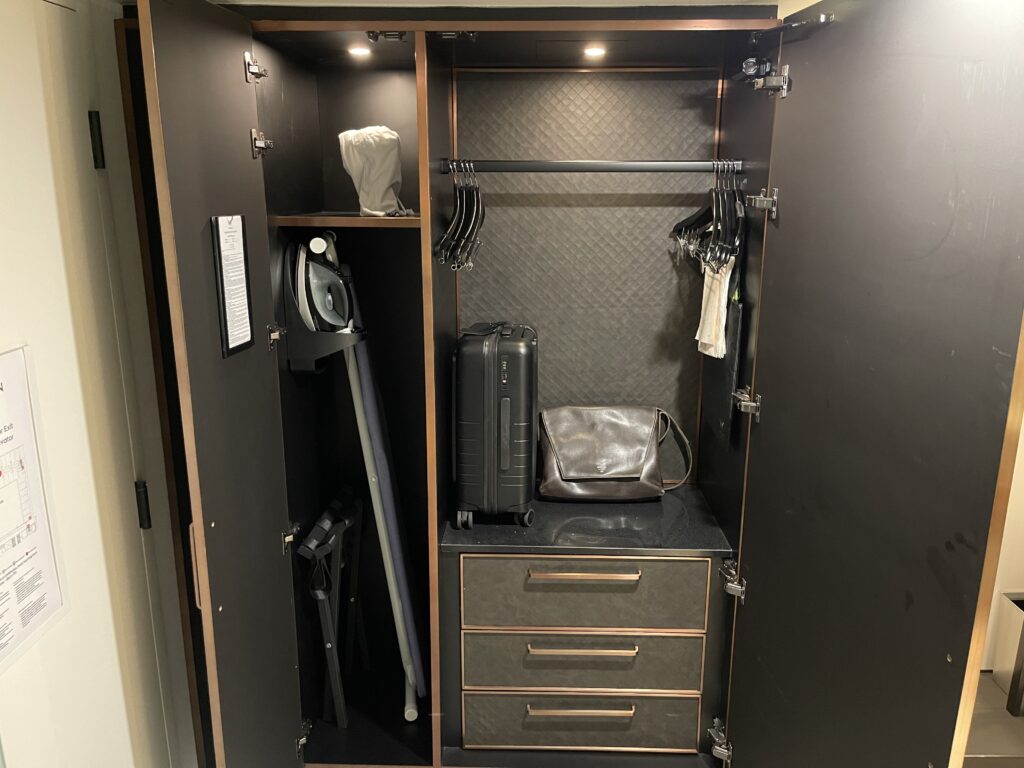 a closet with a black and silver cabinet