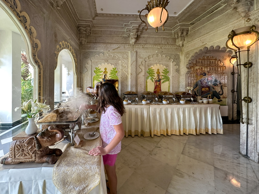 a girl standing at a buffet table