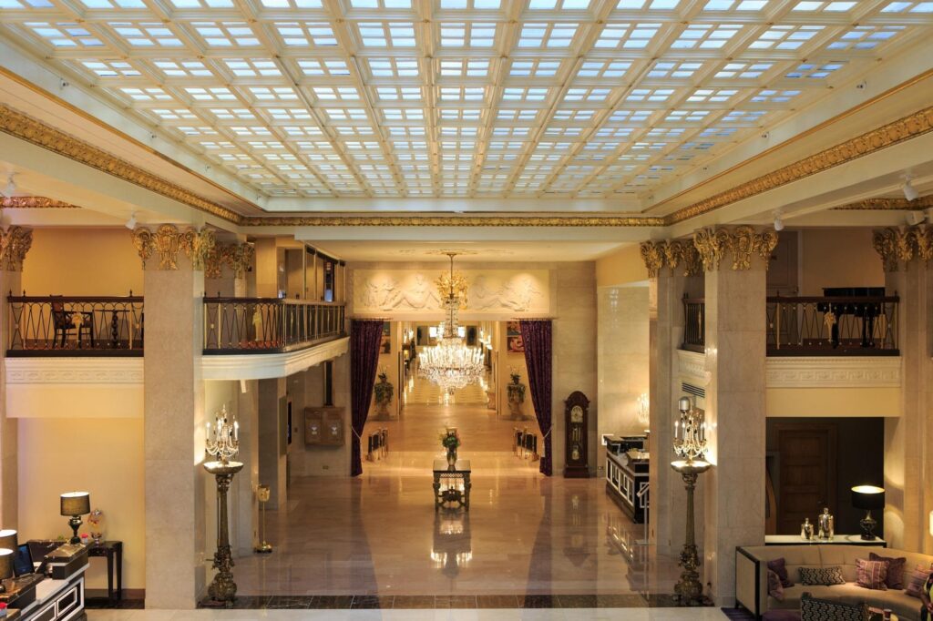 a large hall with chandeliers and a table