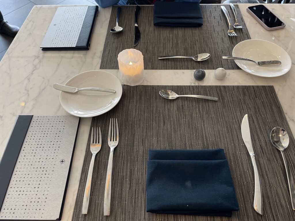 a table with silverware and plates