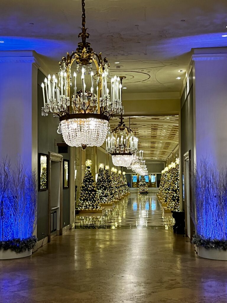 a hallway with lights and chandeliers