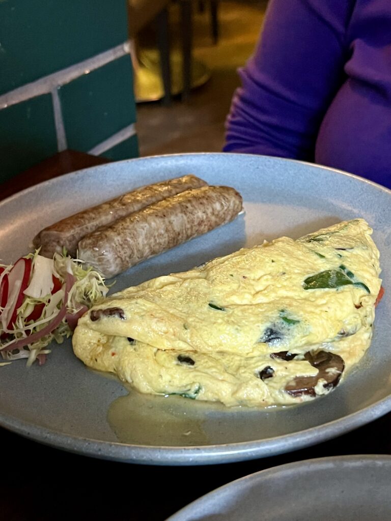 a plate of omelette and sausages