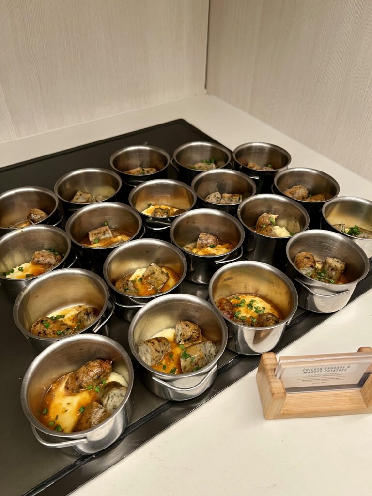 a group of silver bowls of food