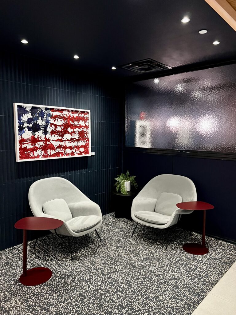 a room with chairs and a flag on the wall