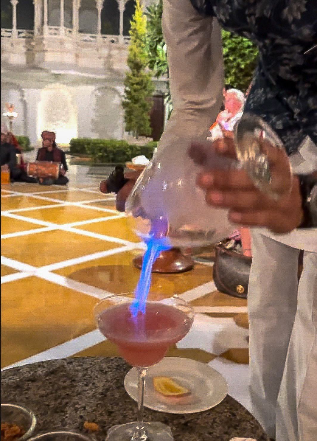 a person pouring a drink into a glass
