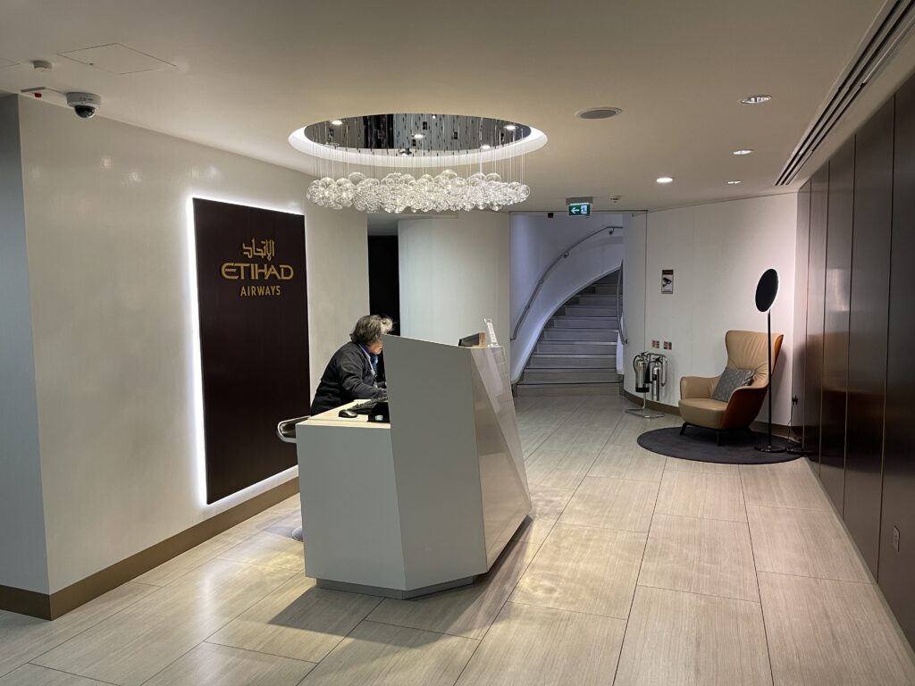 a person sitting at a reception desk in a hotel