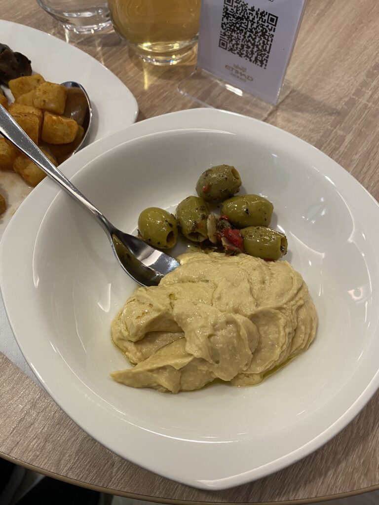 a bowl of hummus and olives