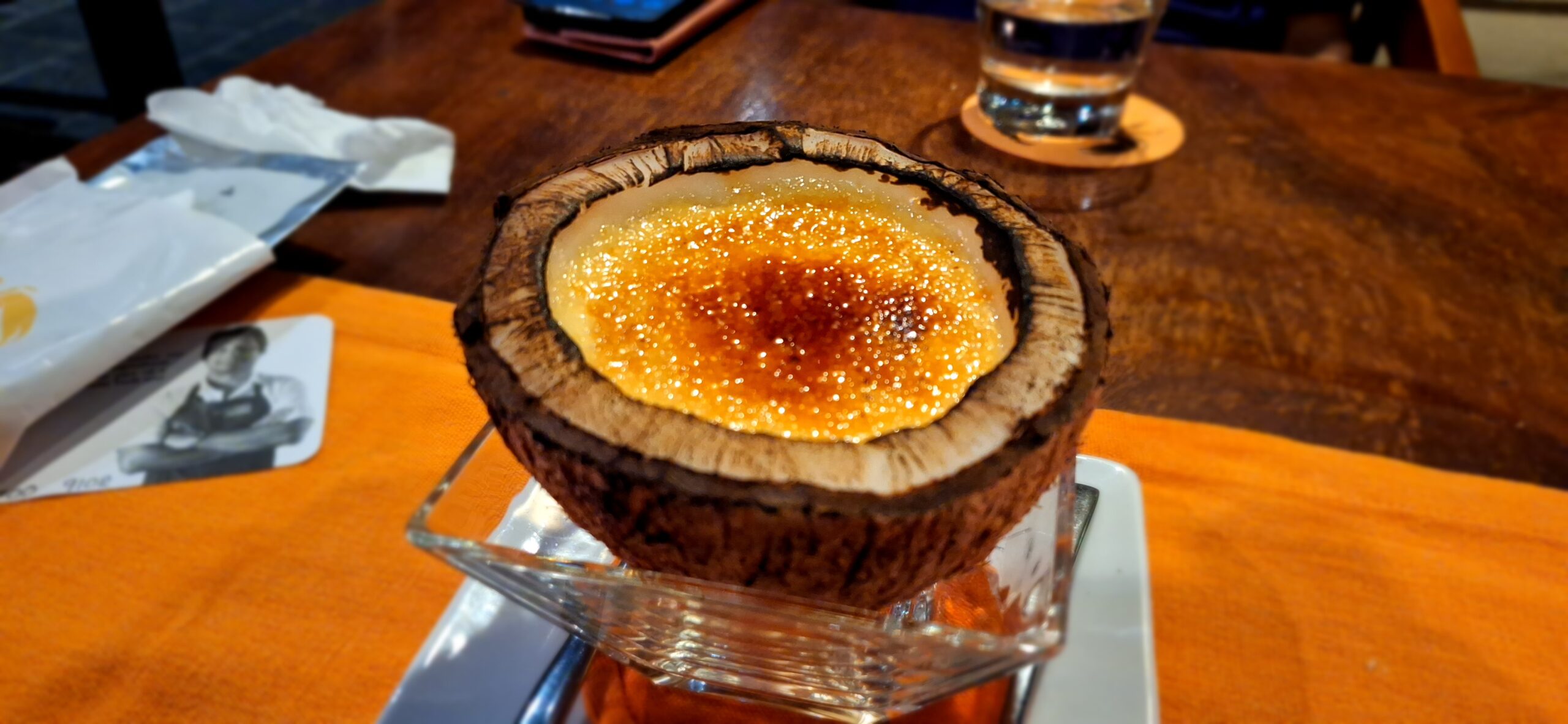 a coconut shell filled with creme brulee
