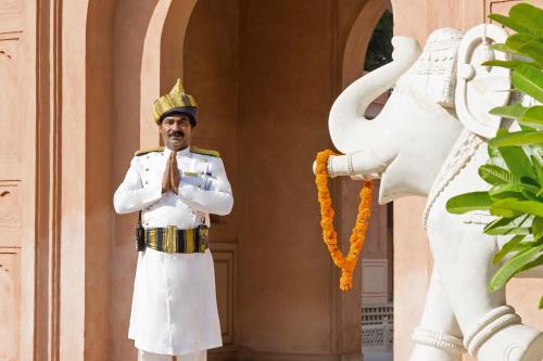 a man in uniform standing next to an elephant statue