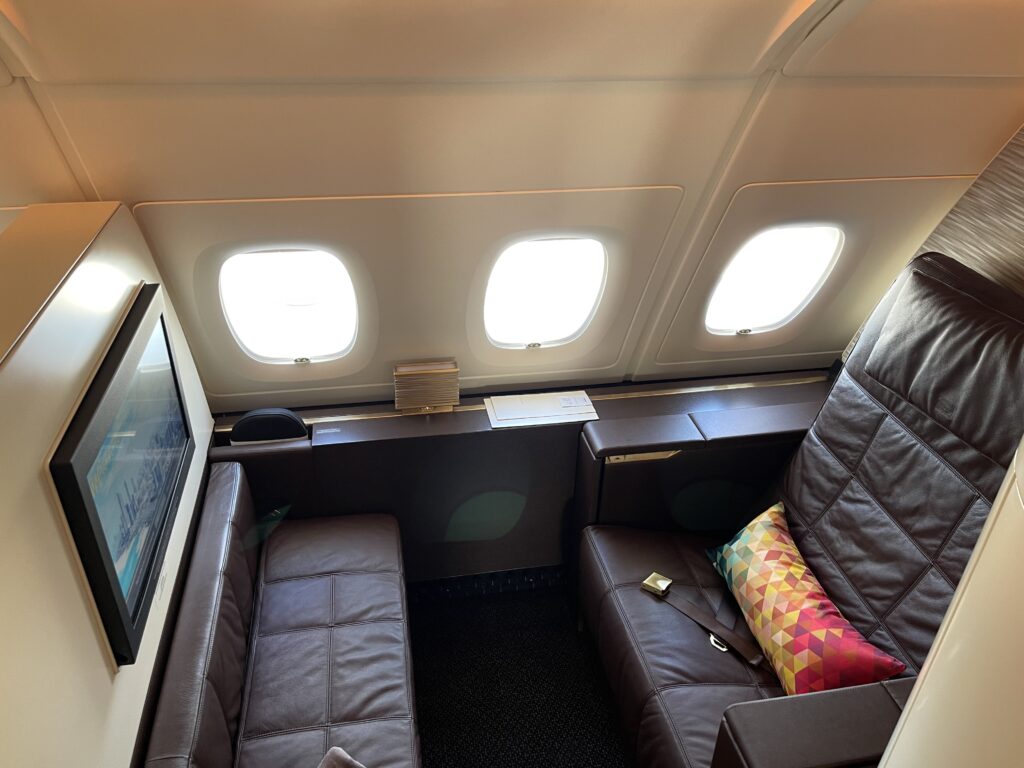 a seat and a tv in an airplane