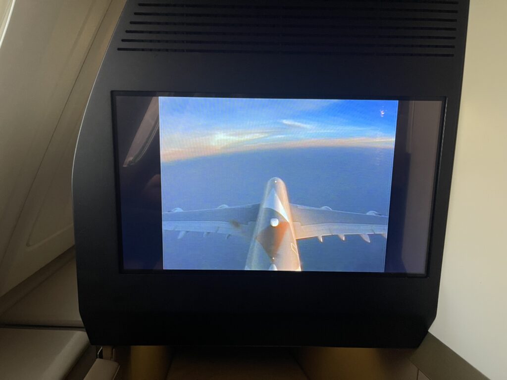 a screen with an airplane in the sky