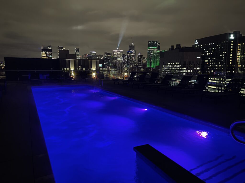 a pool with a city skyline in the background